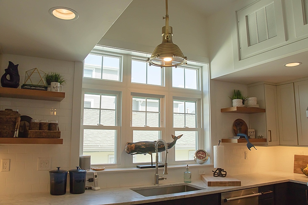 Double-hungs, mulled triple transom over triple double-hung window wall