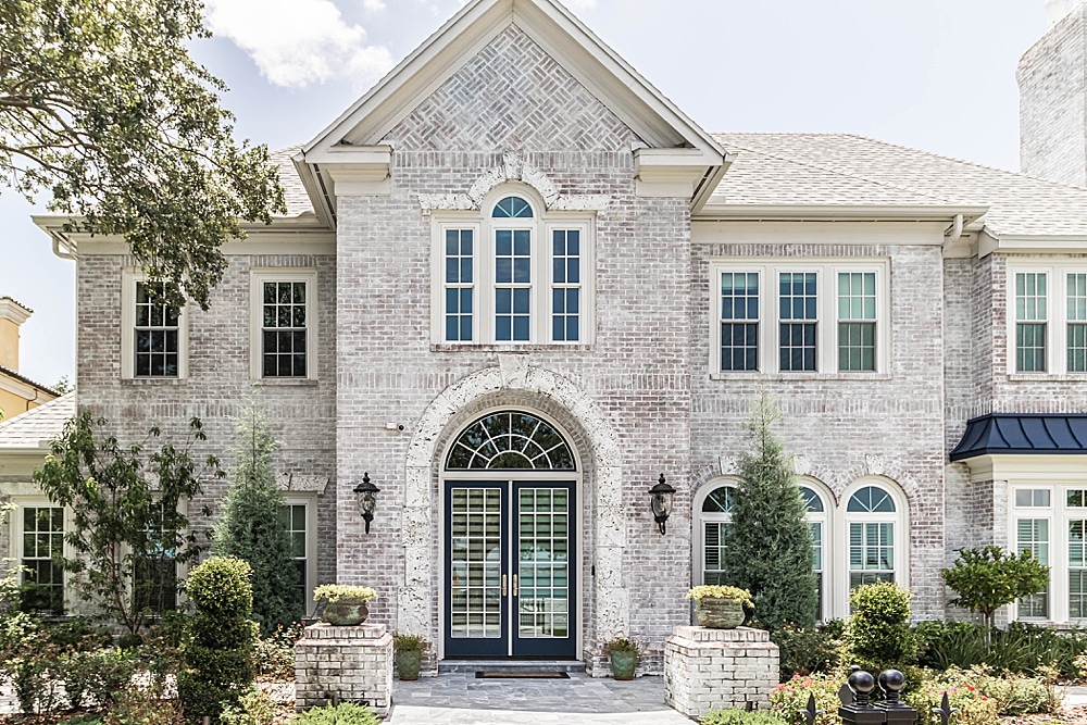 Viwinco OceanView white single-hungs, transoms, and half-round windows installed in Colonial home remodel.