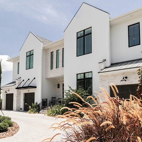 Viwinco black laminate windows installed in modern English farmhouse.