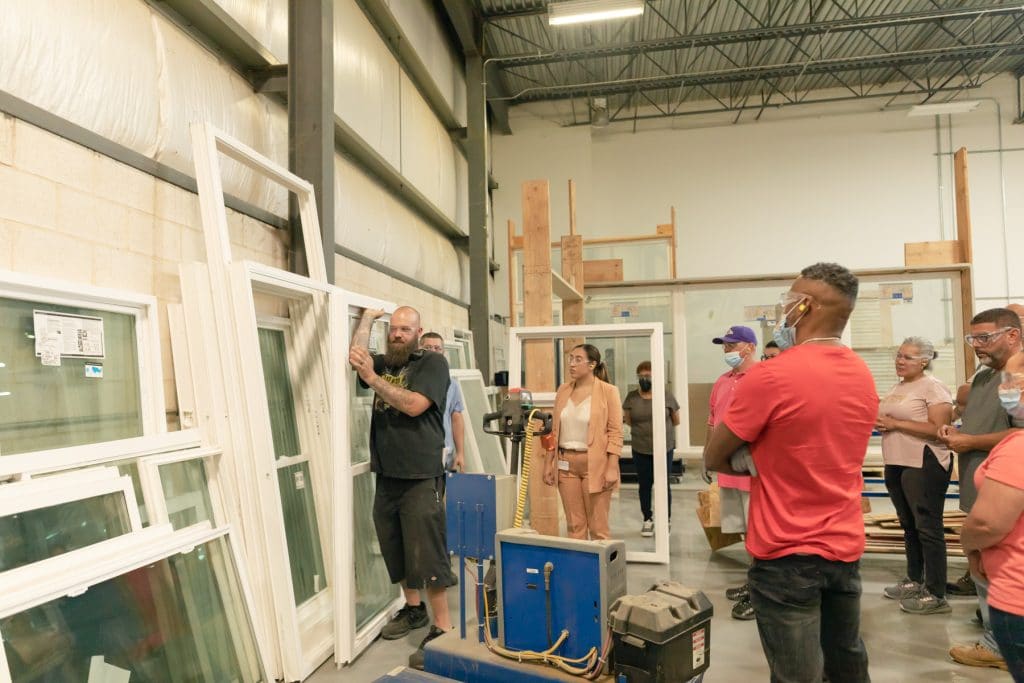 OnboardingTraining 2021-6 Group of people receiving onboarding training in glass production warehouse