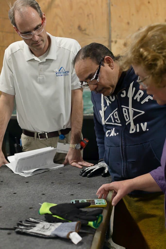 Sharon-Safety Post-5 Man speaking to woman in glass production warehouse