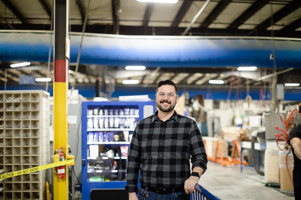 Zach-Safet Post-2 Portrait of Viwinco team member wearing safety glasses in Viwinco glass facility.